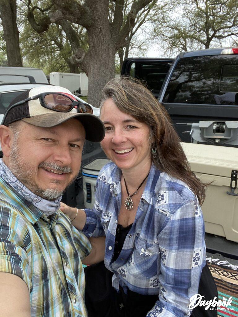 two people sitting on a tailgate