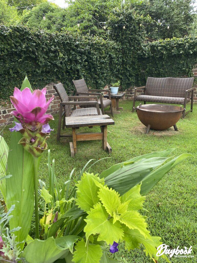 outside seating area with a firepit and garden