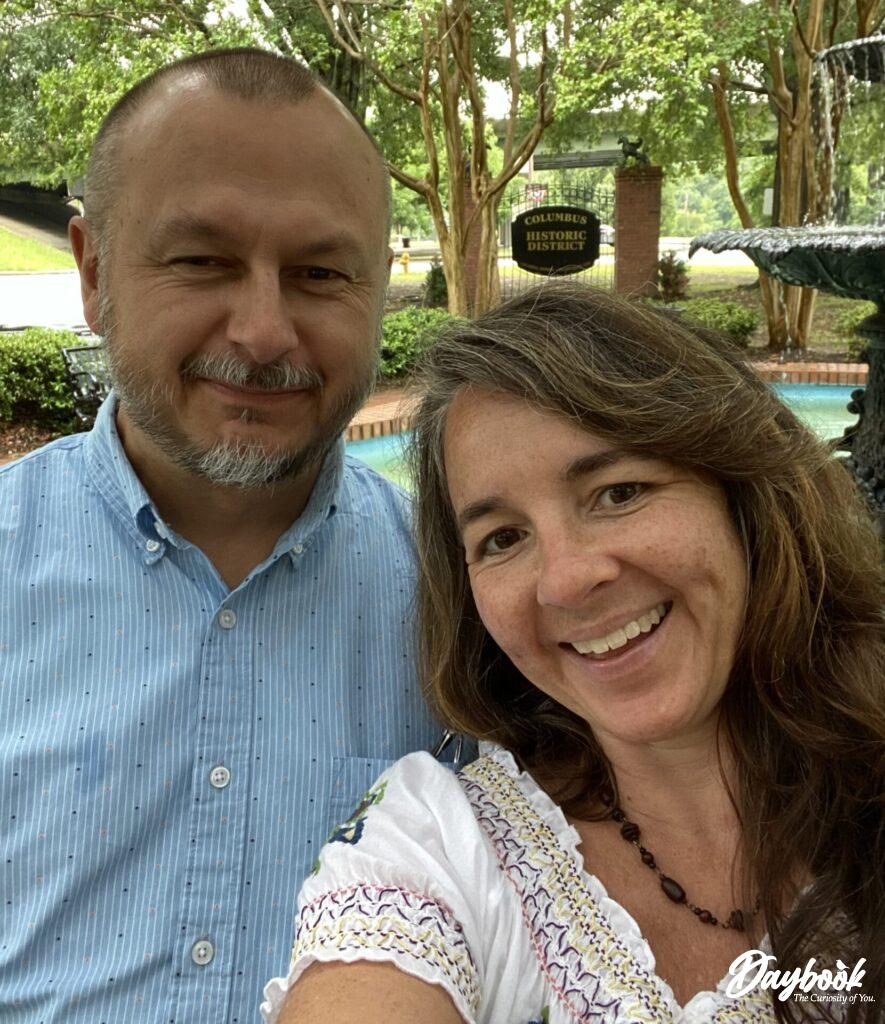 man and lady in front of Columbus GA sign