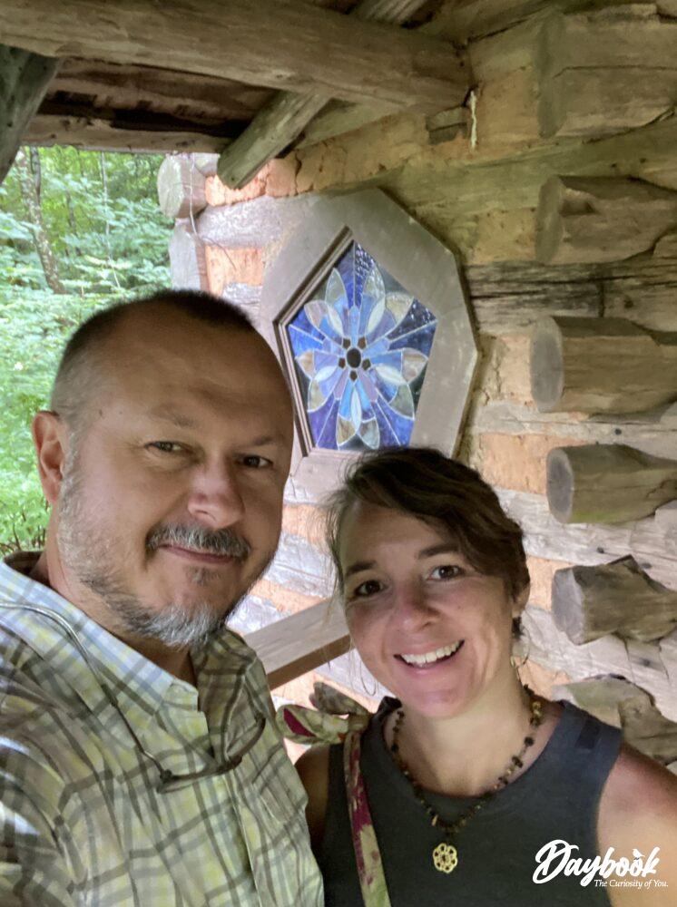 man and woman in front of chapel window