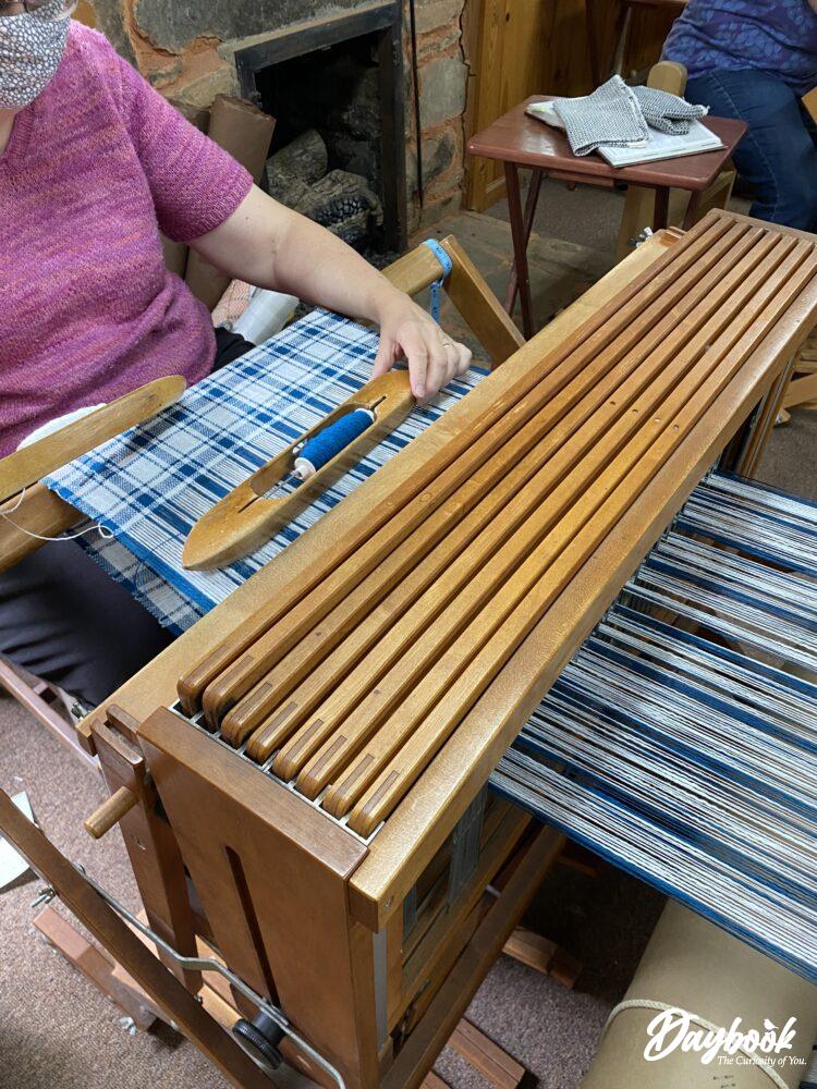 Artisan weaving on a loom