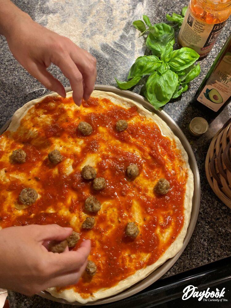 pizza with sauce and sausage