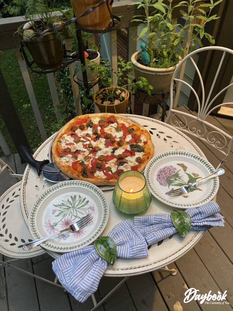 outdoor table set with pizza