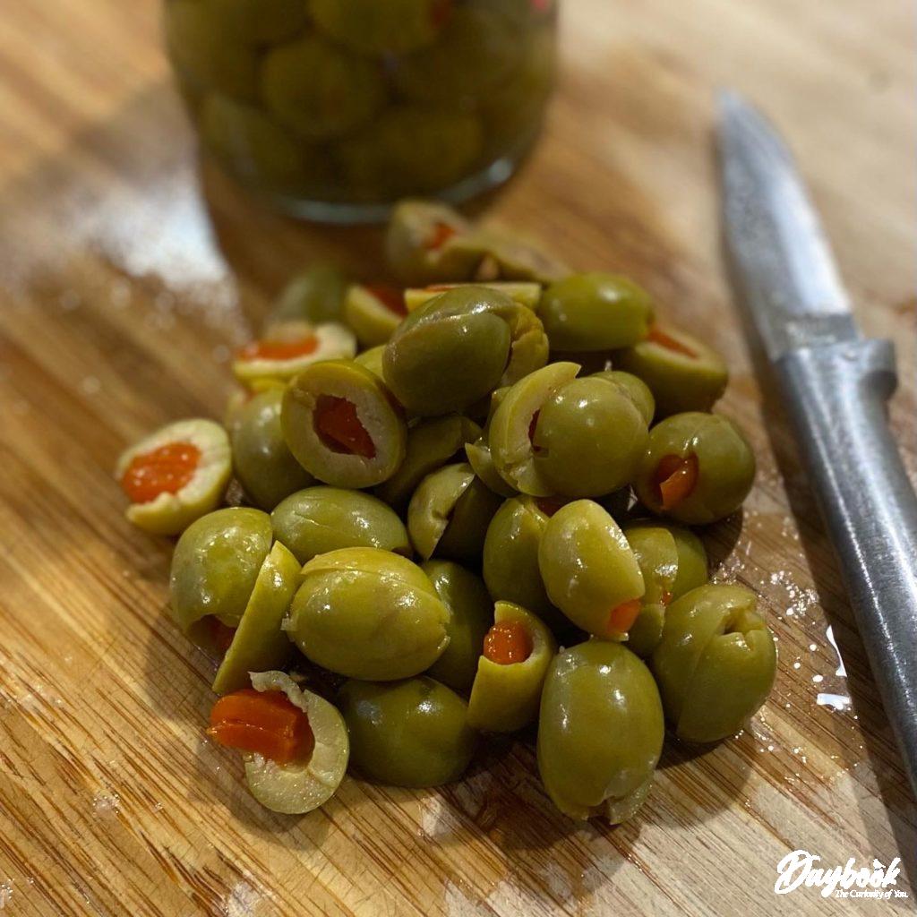 chopped green olives on a cutting board