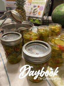 placing lids on jars of pickles