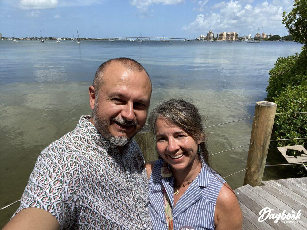 A man and a woman by the Sarasota Bay reflecting on the reasons to visit Botanical Gardens.