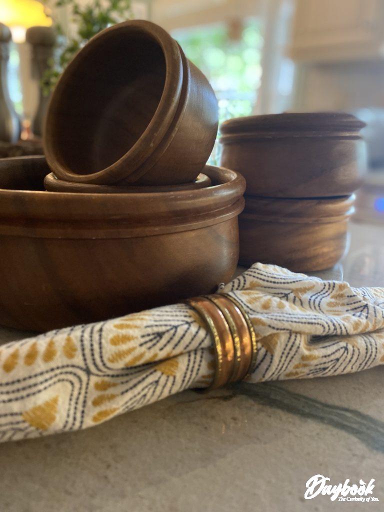 A stack of wooden monkey pod bowls used for dinner or salad.
