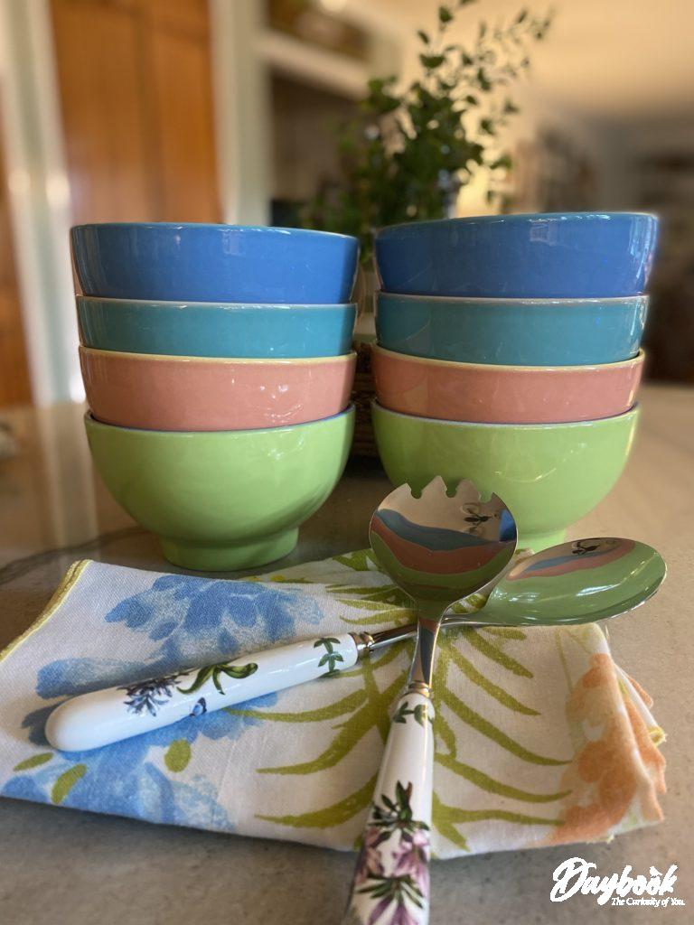2 stacks of multi-colored bowls ready to be used for dinner.
