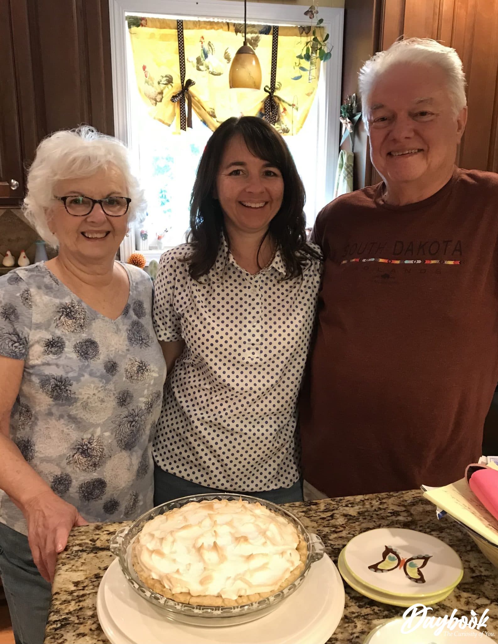 mom daughter and father in a kitchen