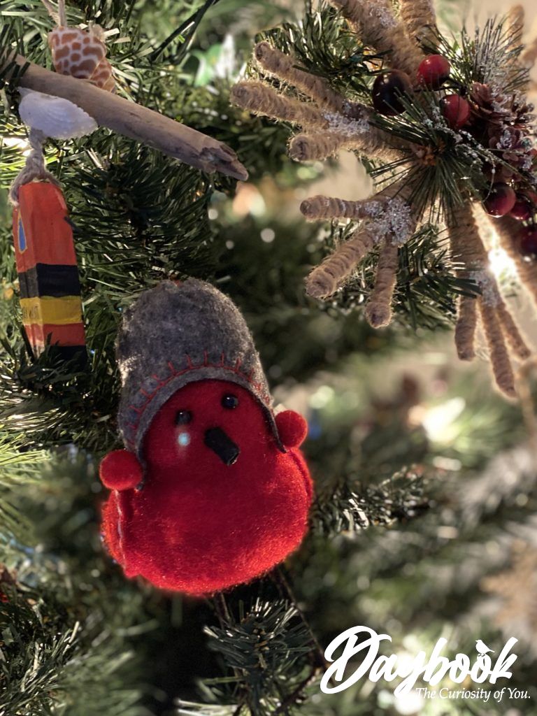 Red bird with grey hat ornament on a tree