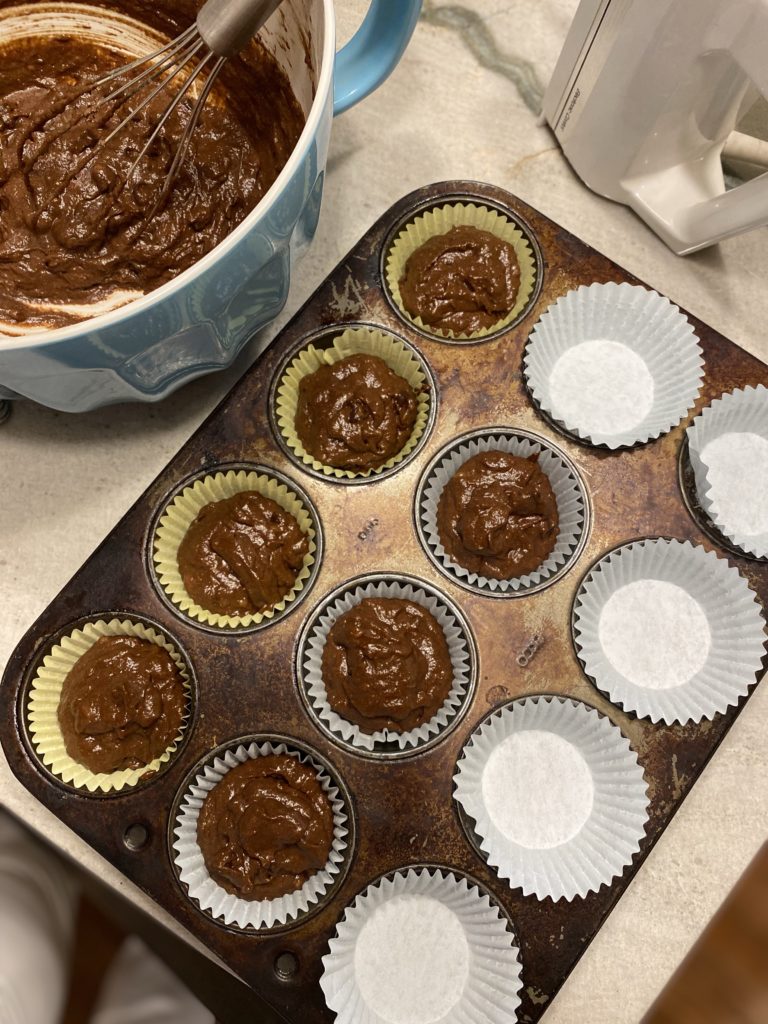 12 muffin pan lined with baking liners and filled with muffin batter