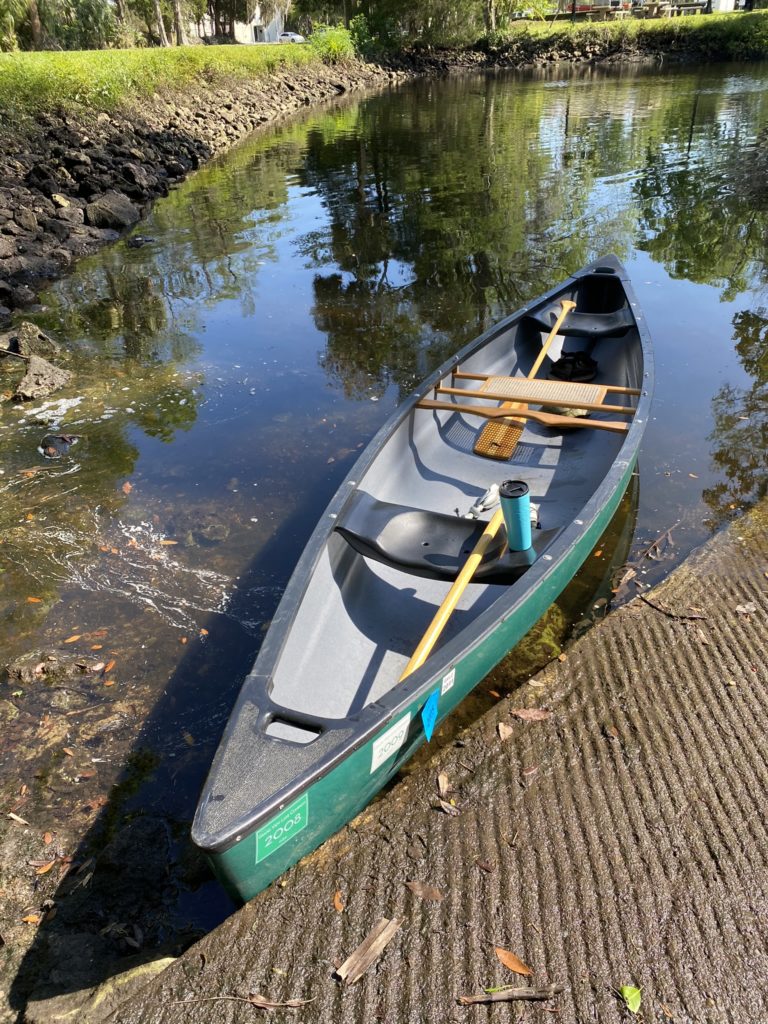 Stepping into our new canoe at the Withlacoochee boat ramp in Florida.
