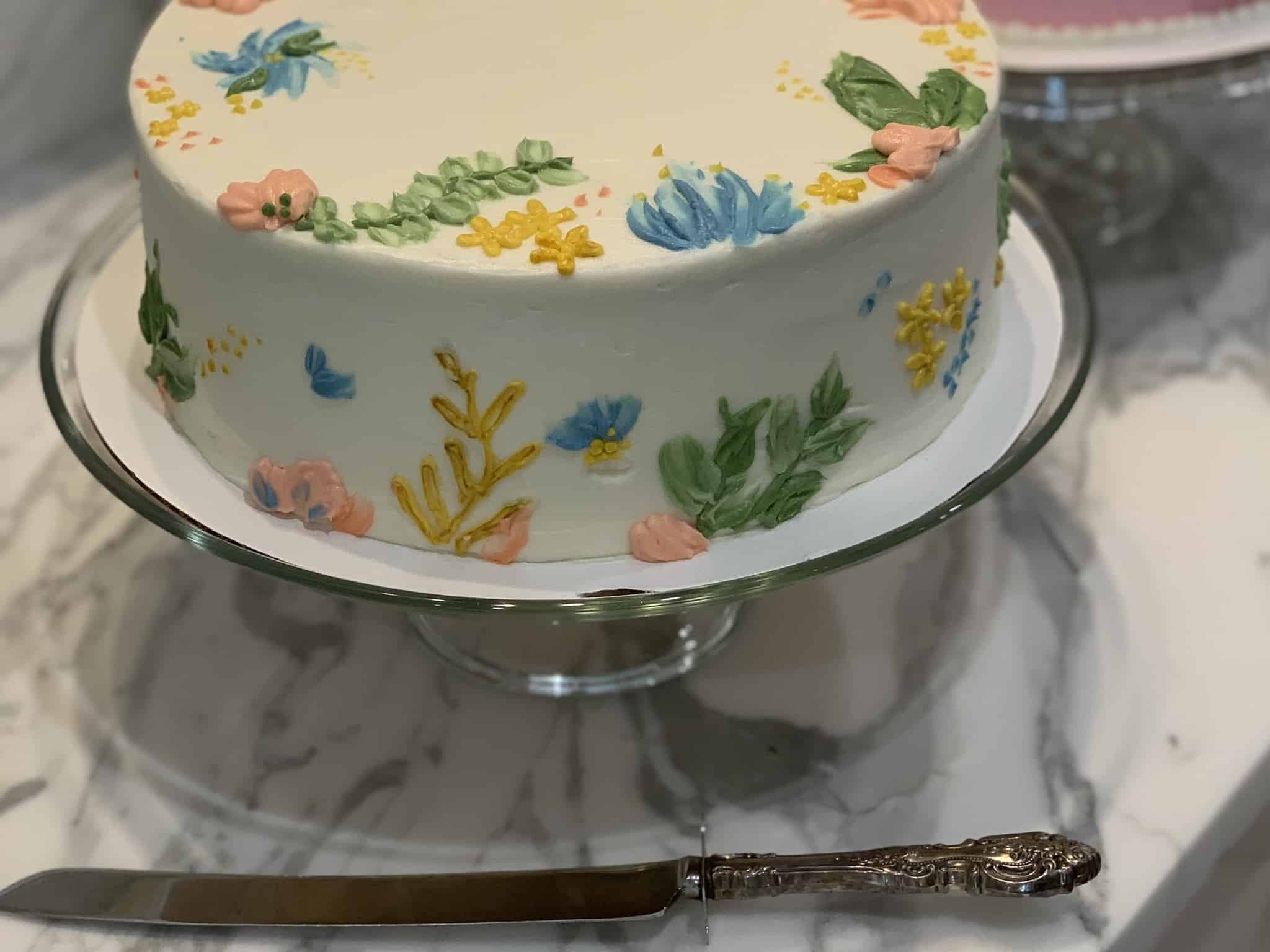 A side view of a beautifully decorated baby shower cake