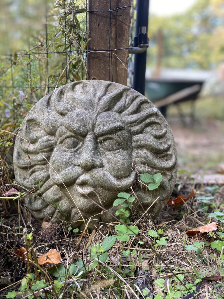 Concrete figure of old man sun and wind