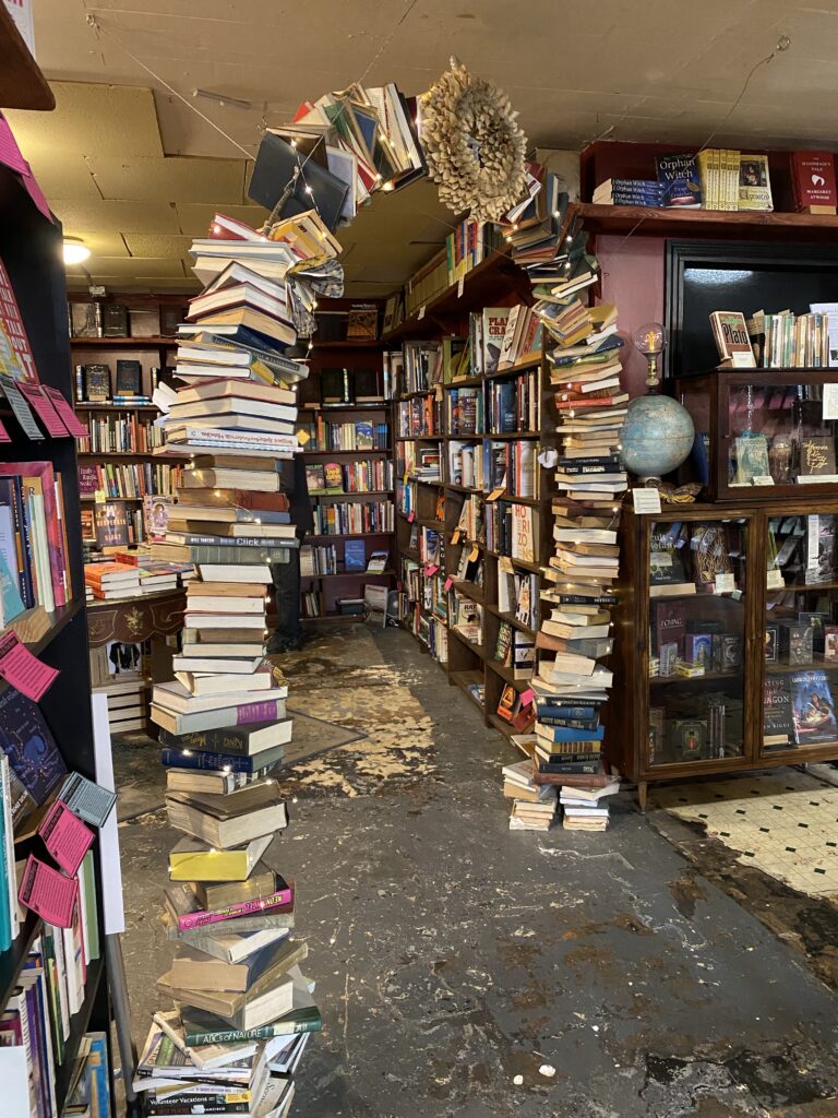 An archway made of books inside of a bookstore.
