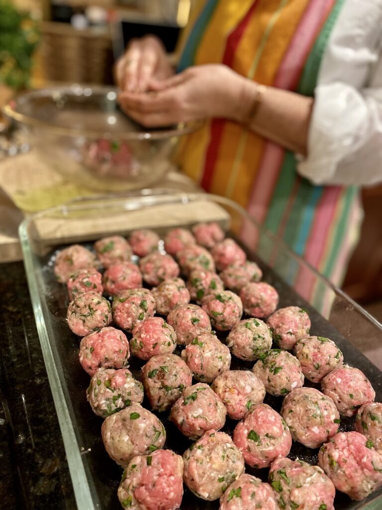 Lady making Italian meatballs for soup